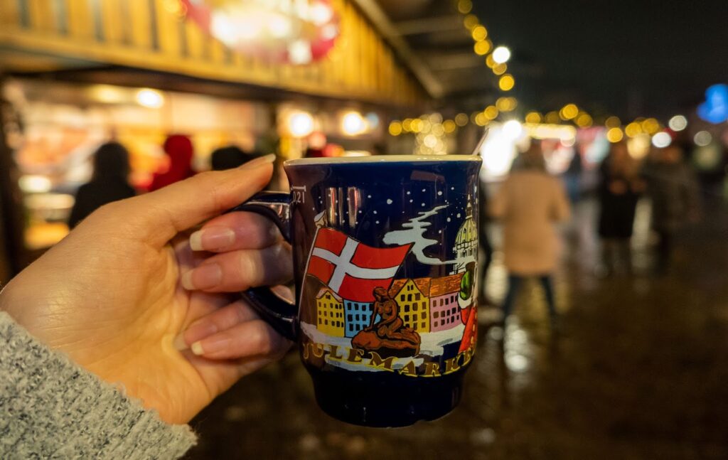 Holding my souvenir Copenhagen Christmas Market mug at the Kongens Nytorv Christmas Market