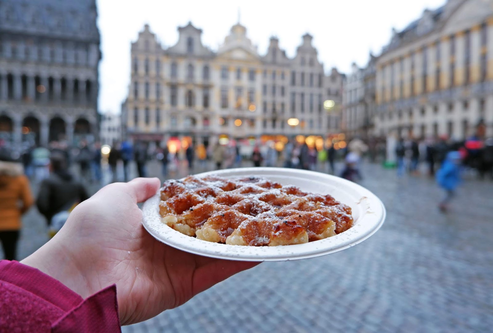 Eating a Liege waffle in the Grand Place, Brussels