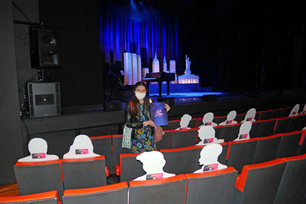 Kat Masterson next to the Tell Me On A Sunday set at The Marlowe Theatre, Canterbury