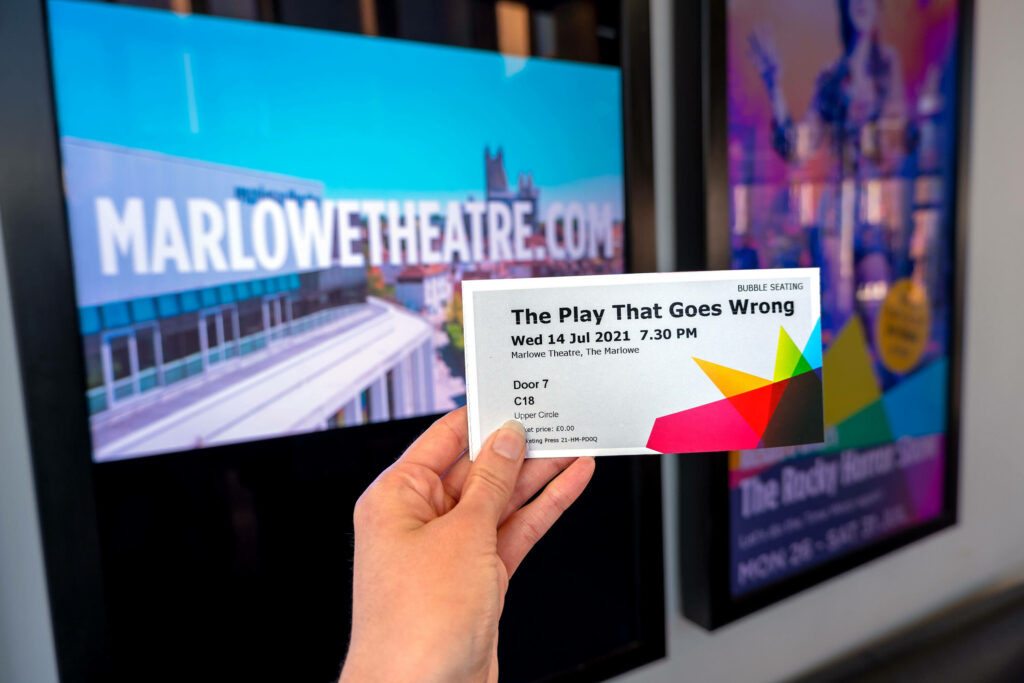 The Play That Goes Wrong ticket in The Marlowe Theatre lobby, Canterbury