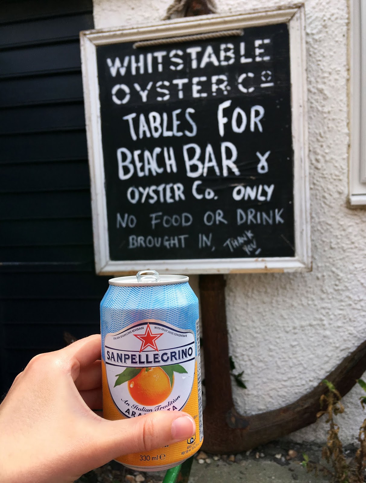 Having a San Pellegrino fizzy orange drink at the Whitstable Oyster Co. bar in Whitstable