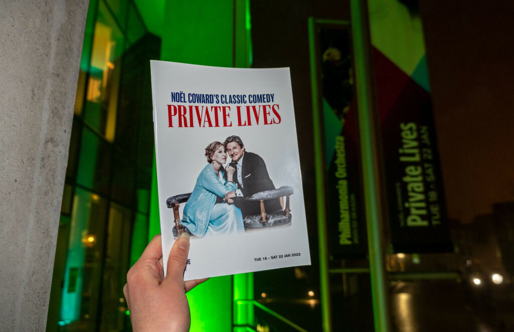 Private Lives programme outside The Marlowe Theatre at night