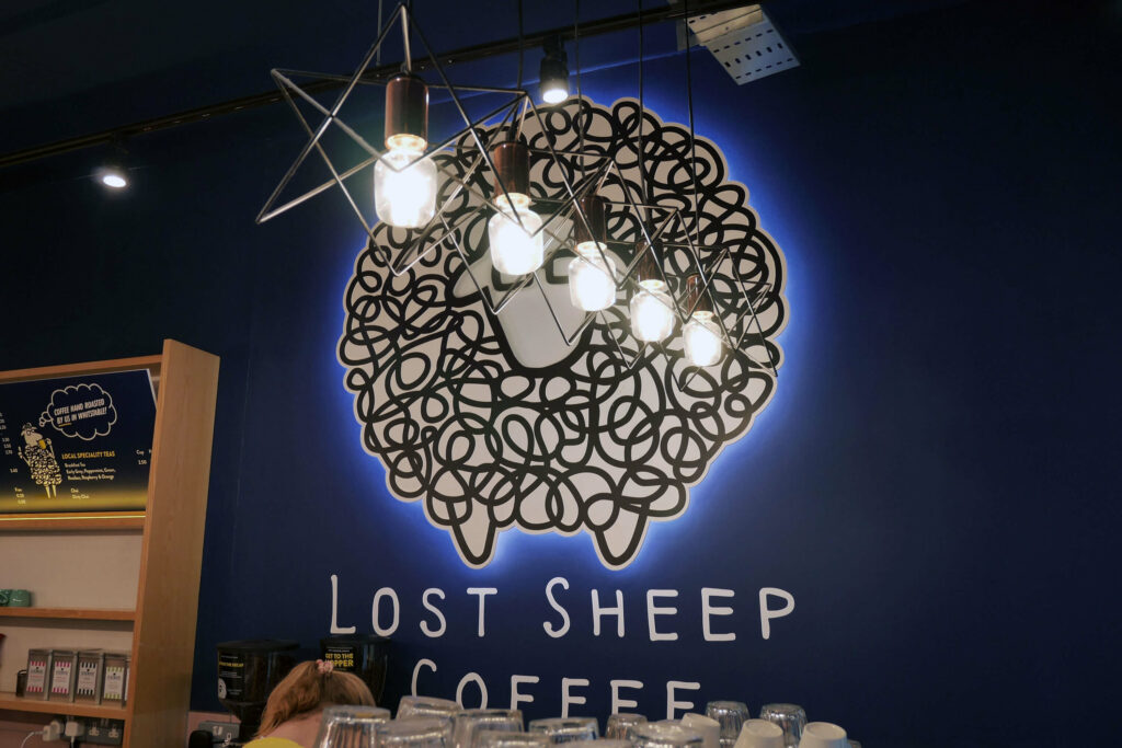 Lost Sheep Coffee and Kitchen branding displayed on a wall inside the cafe