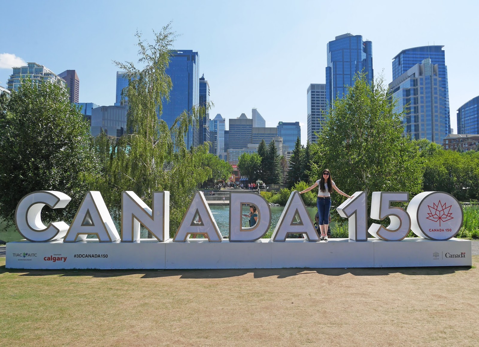 Kat Last standing on the Canada 150 sign at Prince's Island Park, Calgary