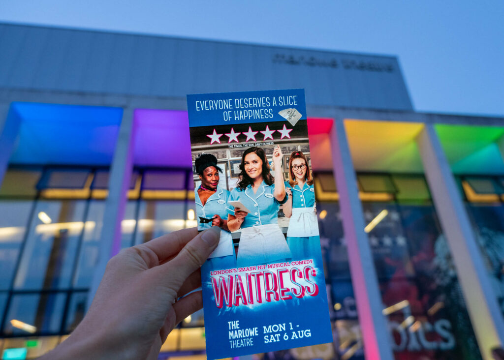Waitress leaflet in front of The Marlowe Theatre, Canterbury