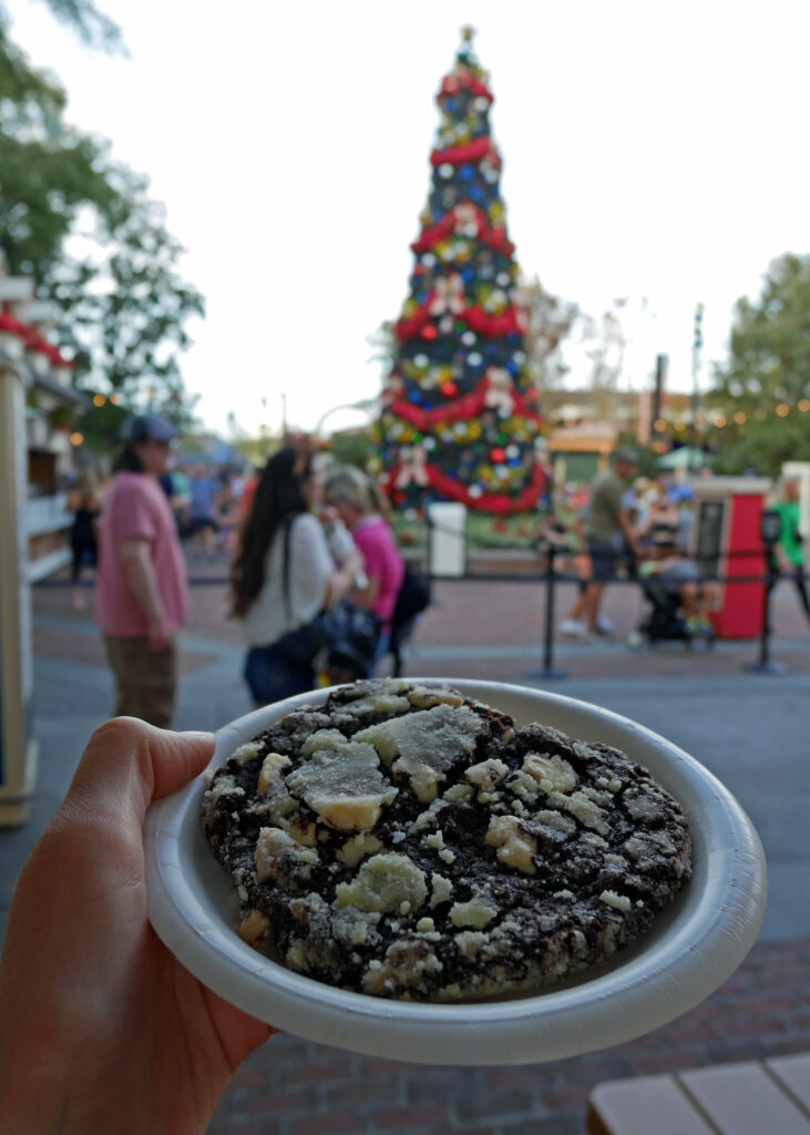 Trying a cookie at the American Adventure Pavilion as part of Epcot's Holiday Cookie Stroll