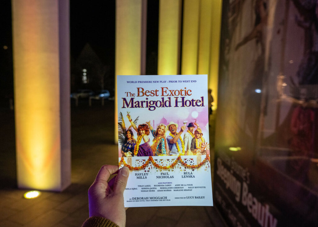 The Best Exotic Marigold Hotel programme outside The Marlowe Theatre in Canterbury, Kent
