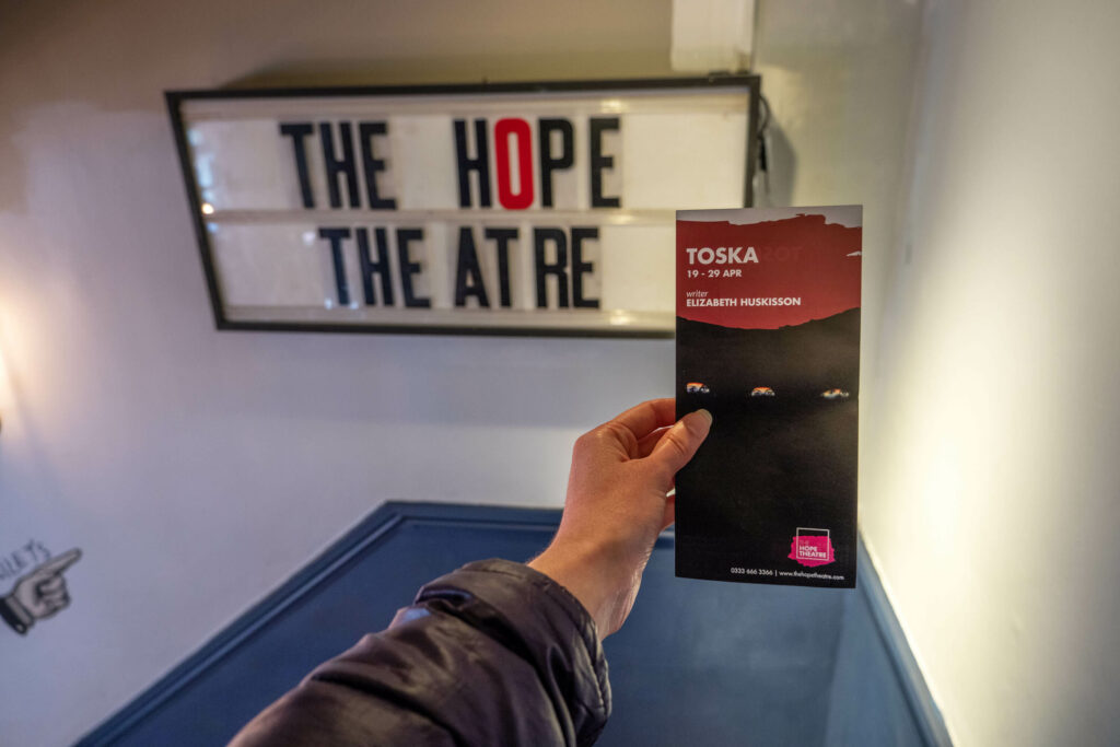 Promotional leaflet for Sort Sol Theatre's TOSKA in front of The Hope Theatre sign in Islington