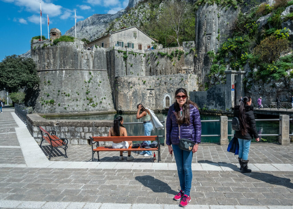 Kat Masterson standing next to the walls of Kotor old town