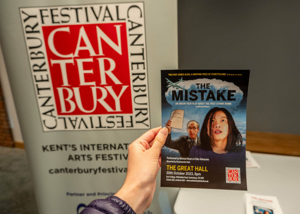 The Mistake leaflet in front of a Canterbury Festival banner