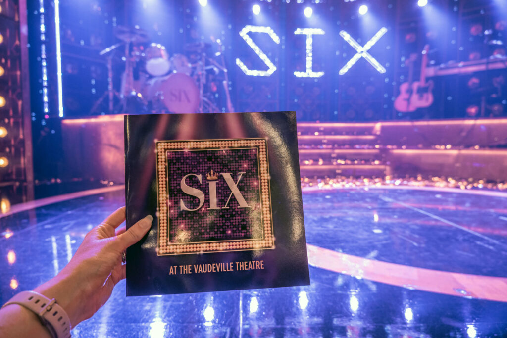 SIX programme in front of the Vaudeville Theatre stage, London