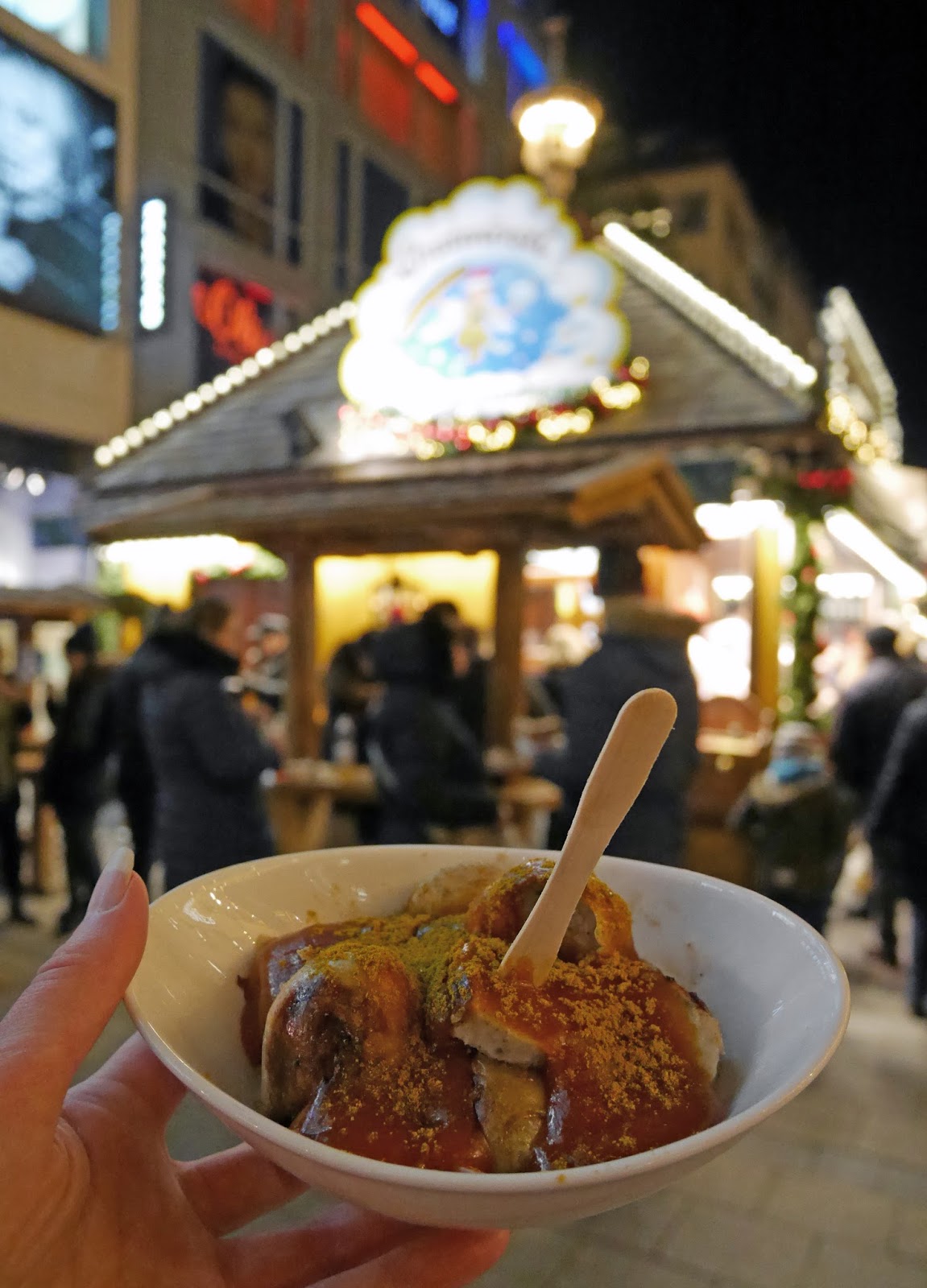 Trying currywurst at the Munich Christmas Markets