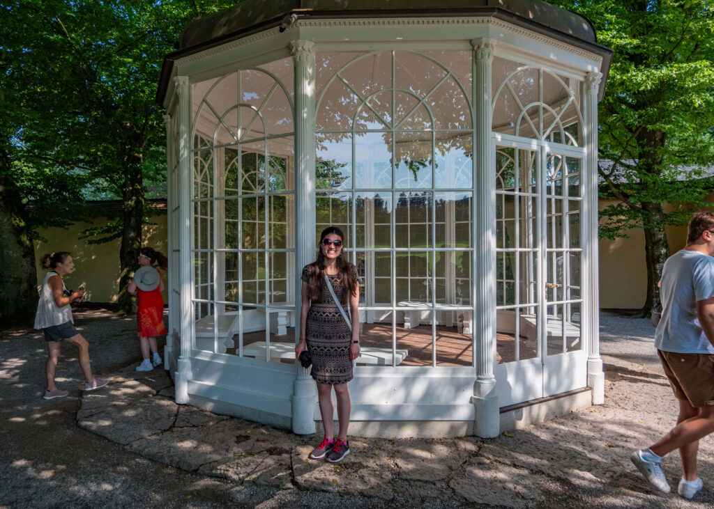 Kat Masterson next to the Sixteen Going On Seventeen Sound of Music gazebo which is located in the grounds of Schloss Hellbrunn, Salzburg