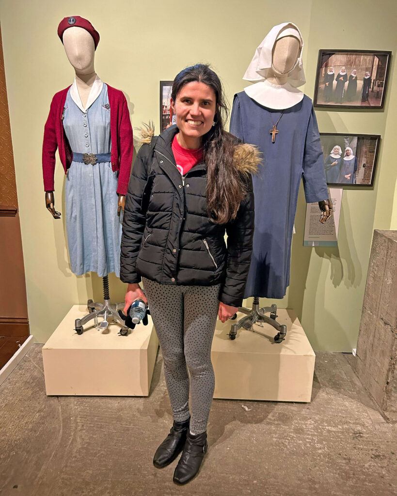 Kat Masterson standing in front of the costumes - Call the Midwife Official Location Tour at the Historic Dockyard in Chatham, Kent
