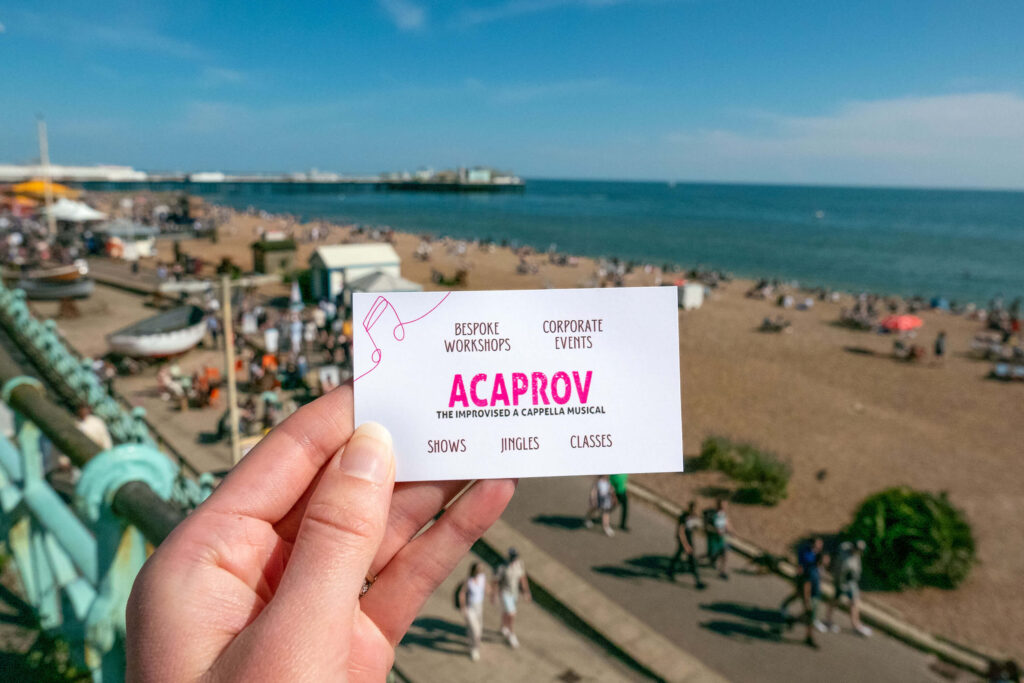 Acaprov: The Improvised A Cappella Musical promotional card on the seafront, Brighton Fringe