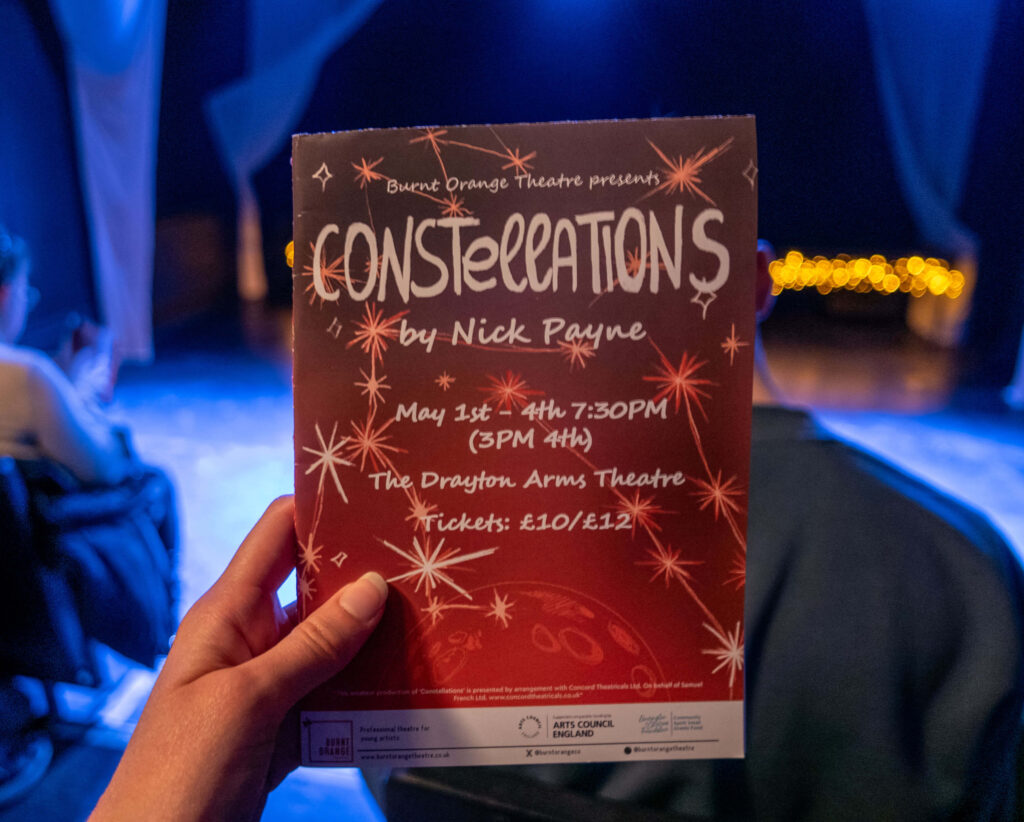 Constellations by Nick Payne programme in front of The Drayton Arms Theatre stage, London
