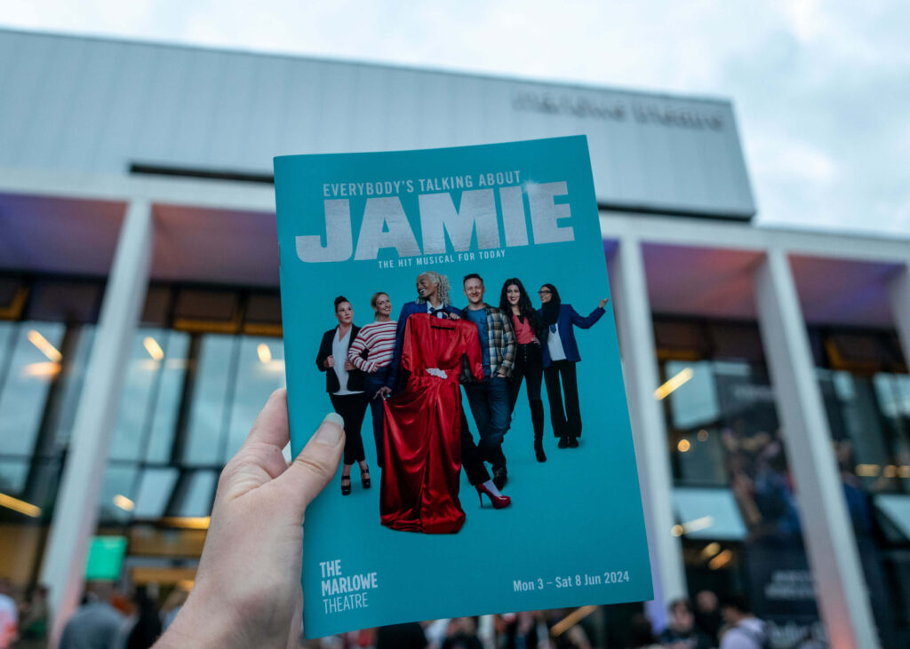 Everybody's Talking About Jamie programme outside The Marlowe Theatre, Canterbury