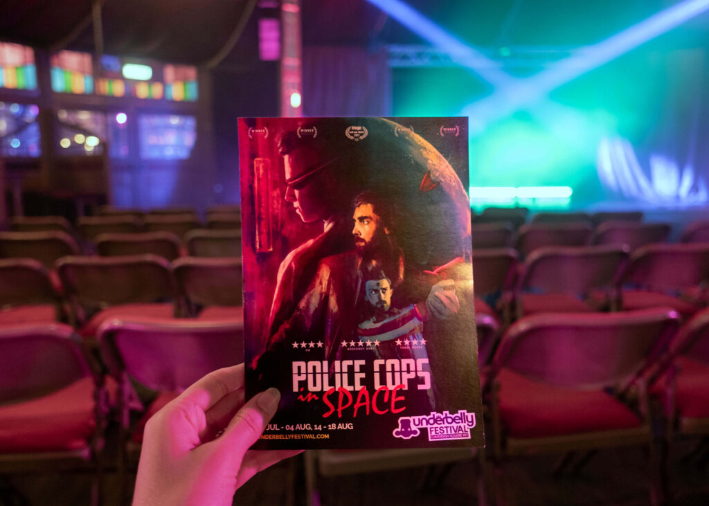 Police Cops in Space leaflet in front of the Spiegeltent stage at Underbelly Festival, Cavendish Square