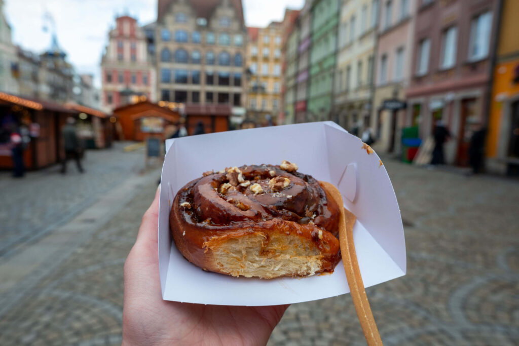 Enjoying a sweet pastry at the Wrocław Christmas Market, Poland