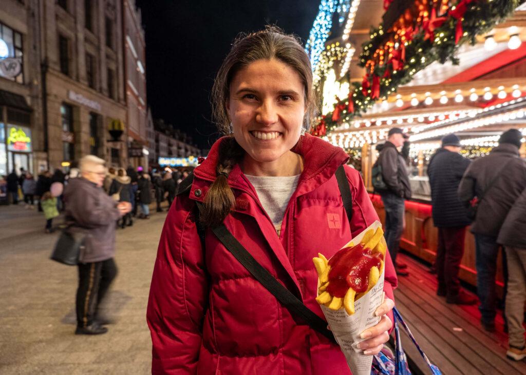 Kat Masterson eating chips at the Wrocław Christmas Market, Poland