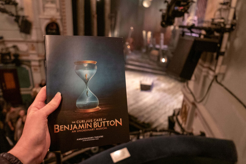 The Curious Case of Benjamin Button programme in front of the stage at the Ambassadors Theatre, London