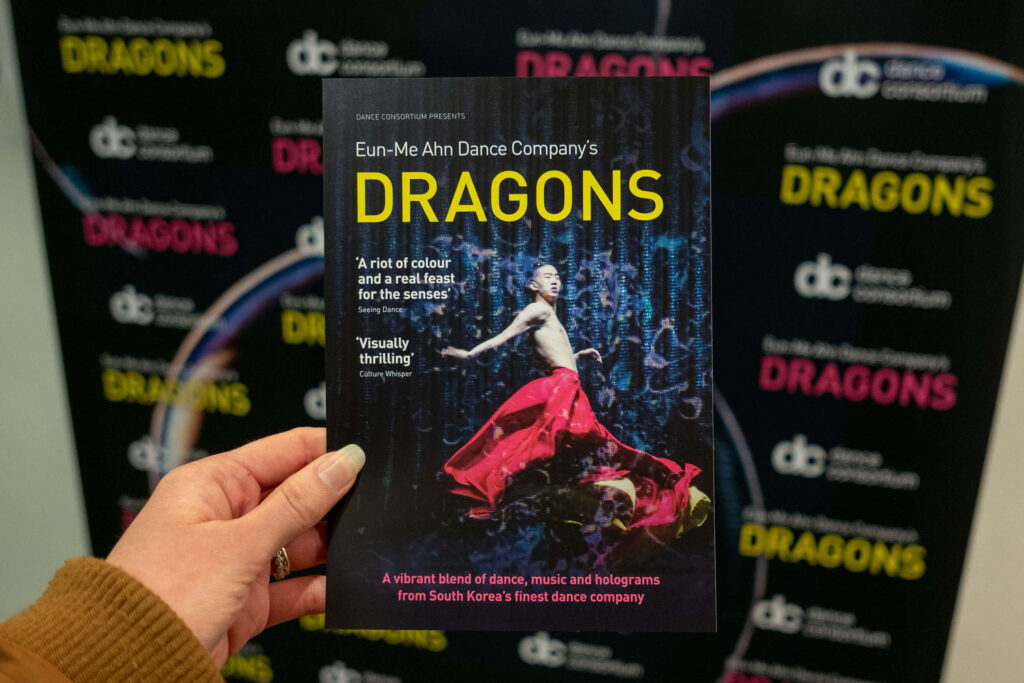 Eun-Me Ahn Dance Company: Dragons leaflet in front of the promotional artwork at the Marlowe Theatre, Canterbury